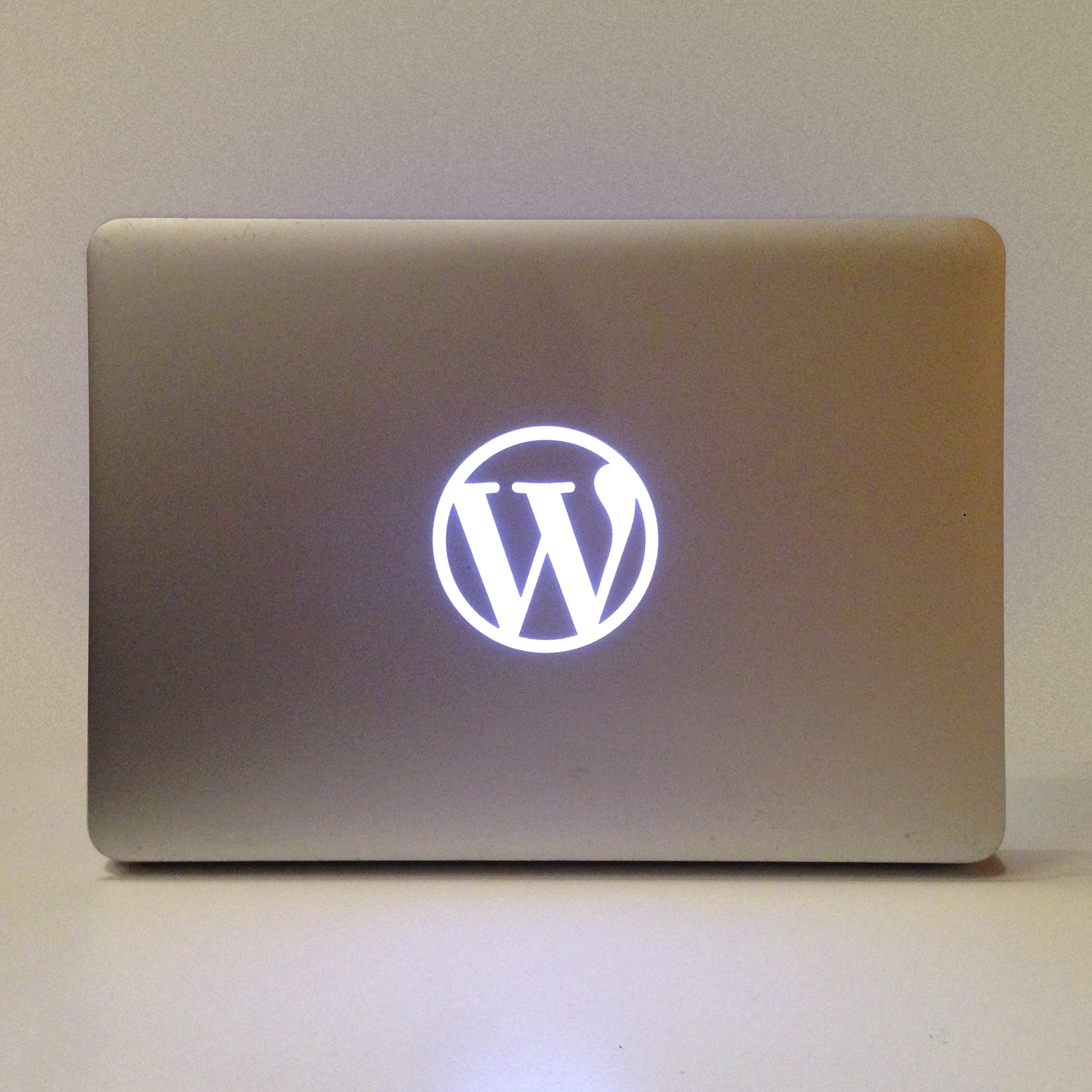 Photo of a customized Macbook Pro, 2012 edition, with the WordPress logo
